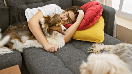 Hispanic woman napping on couch with shetland sheepdog in cozy living room setting