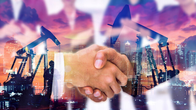 Double exposure of businessman handshake with Crude Oil pump oil rig energy industrial machine for petroleum background