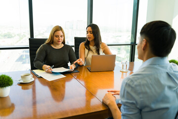 Female interviewers getting ready to ask some questions to a job candidate