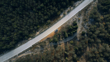 Aerial photo of the parked car near the road in the forest