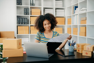 Startup small business SME, Entrepreneur owner African woman using smartphone or tablet taking receive and checking online purchase shopping order