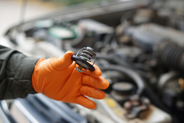 Close up mechanic hand holds metal spare part of car engine. Concept, machine maintenance, fix,...