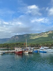 Fototapeta na wymiar fishing boats moored in the bay against the backdrop of high green mountains