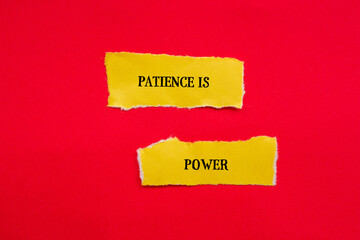 Patience is power lettering on ripped yellow paper with red background. Conceptual symbol. Top view, copy space.