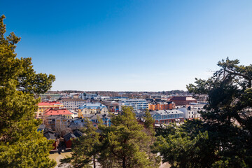 Fototapeta premium Porvoo, Finland - 10 April 2023: Aerial spring view of Old town of Porvoo, Finland. Beautiful city landscape with old colorful wooden buildings and river Porvoonjoki.
