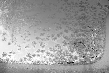 Winter patterns on window glass. The frost on the window froze in intricate patterns. Patterns on glass after frost.