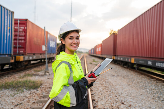 Portrait of woman engineer railway standing and looking camera in train factory. Maintenance cycle concept.