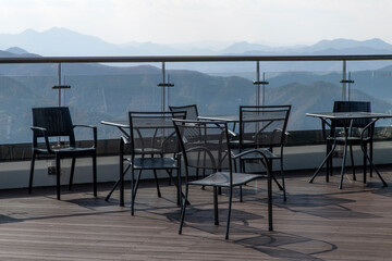 View of table and chairs against the autumn mountain