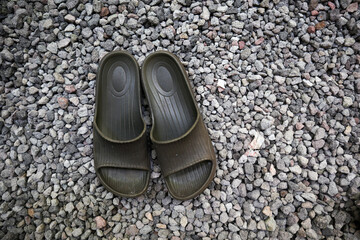 sandals with a background of small rocks or pebbles