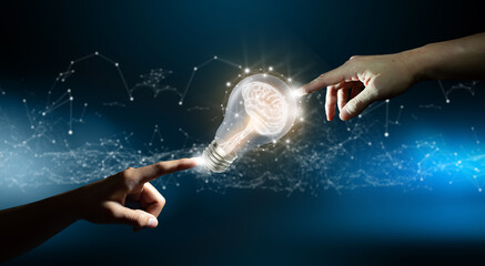 Hands pointing a brain inside a light bulb. Circuit converging point background. Business bright...