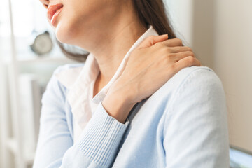 Office workers have neck pain from bad posture during sitting and work.