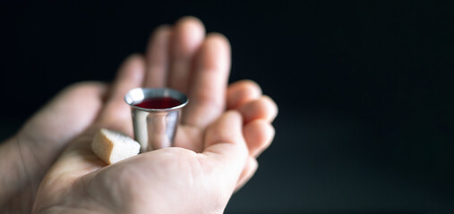 Holy Communion or Eucharist of christianity concept. Eucharist is sacrament instituted by Jesus. during last supper with disciples. Bread and wine is body and blood of Jesus Christ of Christians. - obrazy, fototapety, plakaty