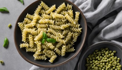 A bowl of pasta with green leaves on top