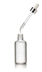 Drop falls from a pipette into a cosmetic bottle