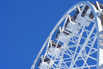Elements of Ferris Wheel on blue sky background. Attraction in the recreational park in Bukovel.