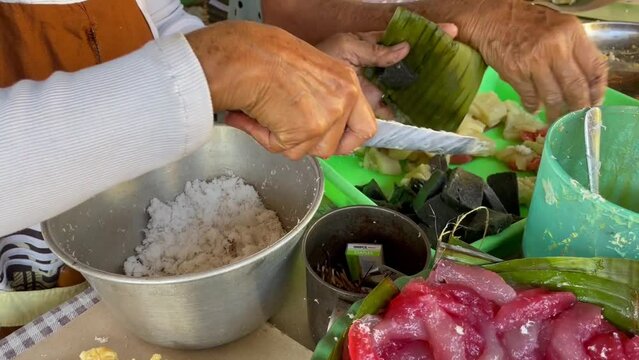 Traders of traditional Central Javanese foods such as Cenil, getuk, corn, coconut and granulated sugar serving buyers by cutting the food and wrapping it in banana leaf containers.