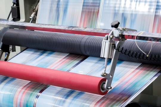 new innovative technology of automatic label printing machine with digital control panel. printing on continuous plastic film for wrapping on food product packaging in the printing factory.