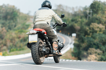 Obraz premium motorcycle in a sunny motorbike on the road riding.with sunset light. copyspace for your individual text. dry road 