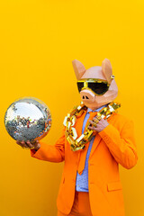 Cool man wearing colorful stylish suit with 3d origami animal funny mask on isolated colored...