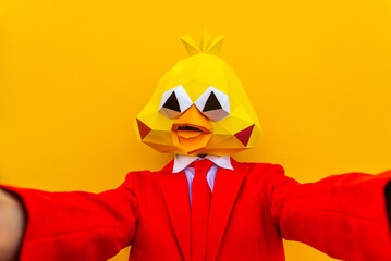 Cool man wearing colorful stylish suit with 3d origami animal funny mask on isolated colored background
