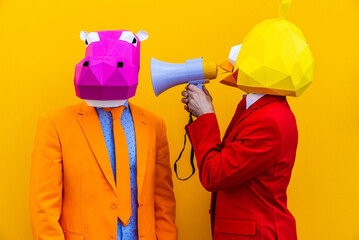 Cool men wearing colorful stylish suits with 3d origami animal funny masks on isolated colored...