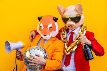 Cool men wearing colorful stylish suits with 3d origami animal funny masks on isolated colored background