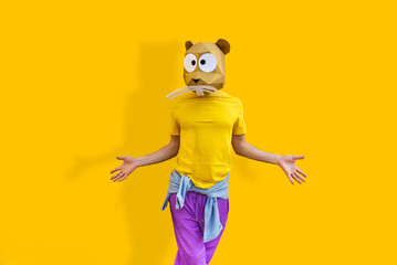 Cool man wearing colorful stylish suit with 3d origami animal funny mask on isolated colored background © oneinchpunch