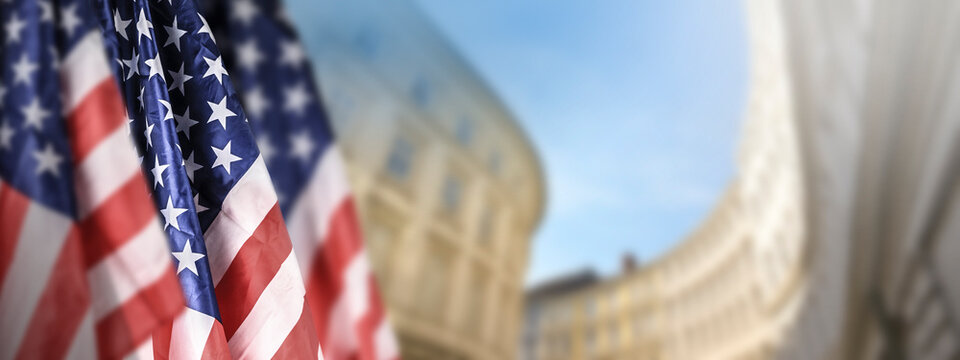 American flag on july 4th with gouverment building in the background. 