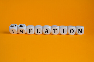 Inflation or skimpflation symbol. Concept words Inflation Skimpflation on beautiful wooden blocks. Beautiful orange background. Business inflation skimpflation concept. Copy space