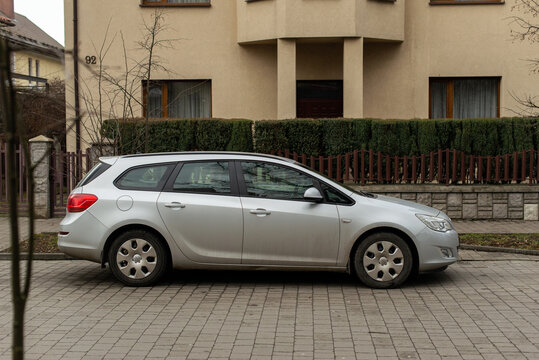 Ivano-Frankivsk, Ukraine - 31 Jan 2023: gray Opel Astra J - station wagon family car. Car parking on city street.