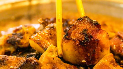 Roast pork in a pan is charred and black. It is a carcinogen. It is dangerous to health. Chopsticks...