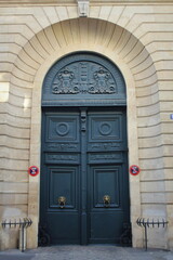 Old fashioned front door entrance, white facade and blue door, Paris, France