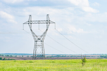 high-voltage power line support on the field. transmission of electricity and information over long distances