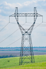 high-voltage power line support on the field. transmission of electricity and information over long...