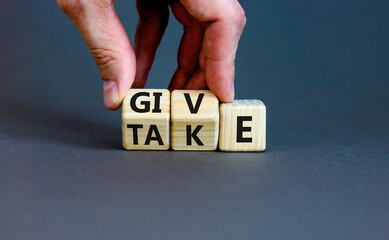 Give or take symbol. Concept word Give or Take on wooden cubes. Beautiful grey table grey...