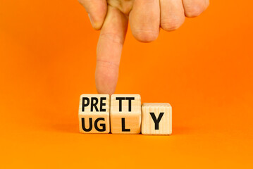 Pretty or ugly symbol. Concept word Pretty or Ugly on wooden cubes. Beautiful orange table orange...