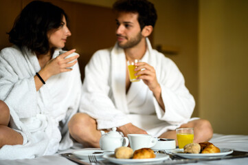 Couple enjoying breakfast in bed together