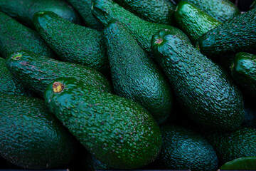 Green Fresh Avocados background for sale at market