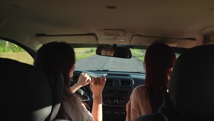dancing girls driving car. travel machine. having fun with music trip, enjoying music, concept...