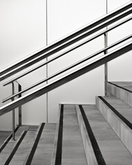 Modern stairway design with sleek metal handrails and contrasting steps in black and white
