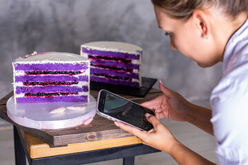 Girl photographs a cake with her smartphone