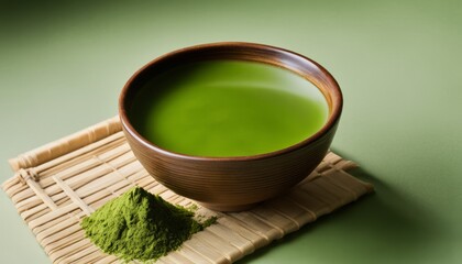 Obraz na płótnie Canvas A bowl of green tea with a spoon and a green tea bag