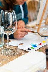 Sip and Paint Event. Mixing colors. Empty wine glass.