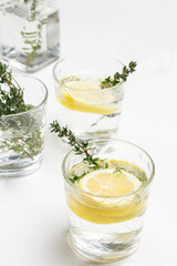 Glass with lemon and sprig of thyme