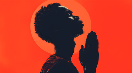 Silhouette of an African black man deep in thought and prayer against a serene background
