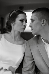 bride with a black car near a glass skyscraper