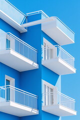 Naklejka premium A white and blue building with balconies in a modern minimalist style. Suitable for banners, presentations and social networks