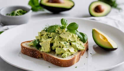 A slice of bread with avocado and a green topping