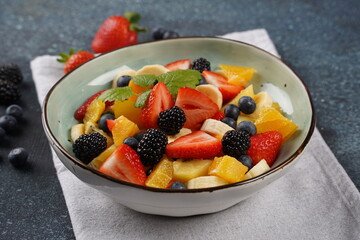 Summer Fruit salad with oranges, strawberries, blueberries, blackberries and fresh mint. Healthy food