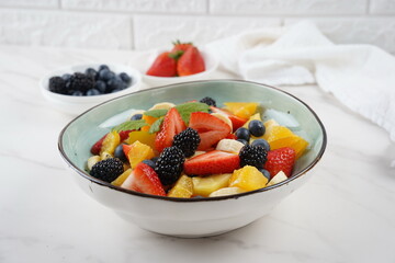 Summer Fruit salad with oranges, strawberries, blueberries, blackberries and fresh mint. Healthy food